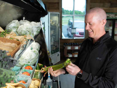 North Kent Connect Staff member stocking produce